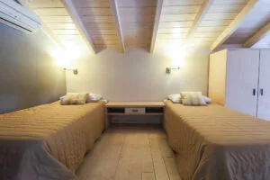 Family House bedroom with two single beds and wardrobe